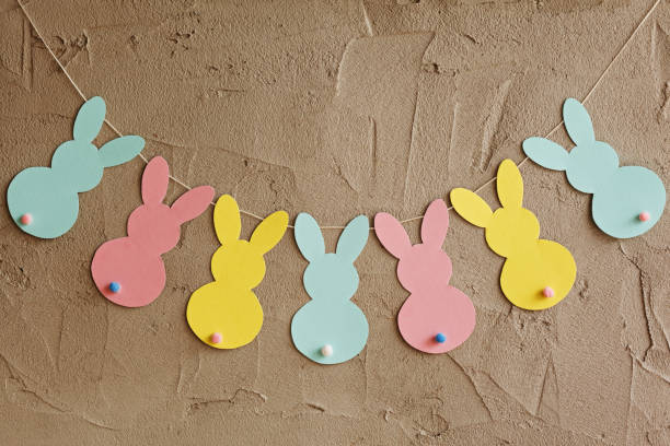 istock Garland with colorful paper rabbits on gray background. Easter concept 650261532