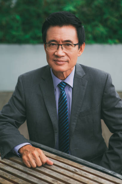 istock Content Senior Businessman Sitting at Cafe Table 650278596
