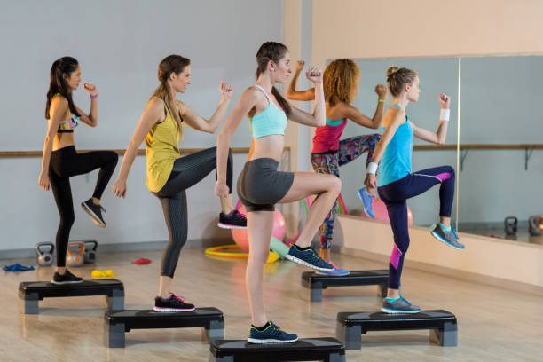 istock Group of women exercising on aerobic stepper 650283990
