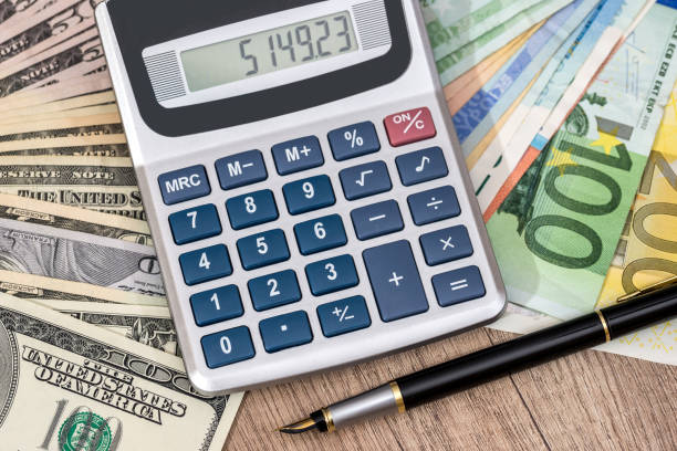 istock euro and dollar banknotes with pen, calculator. 650297930