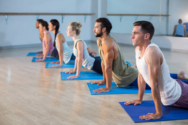 istock Group of people performing yoga 650298514