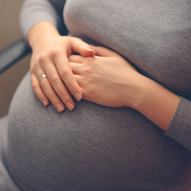istock Woman holding her hands on stomach - Pregnancy concept 650323712