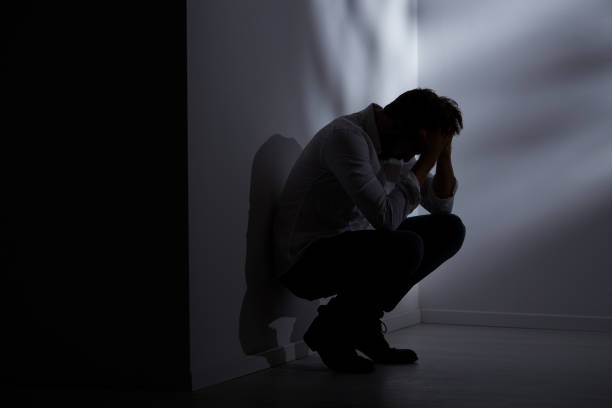 istock Abandoned man sitting beside wall 650326508