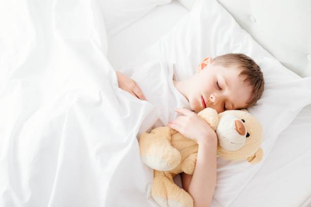 istock Little boy child sleeping in bed 650335774