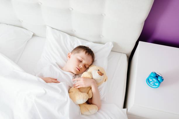 istock Little boy child sleeping in bed 650338176
