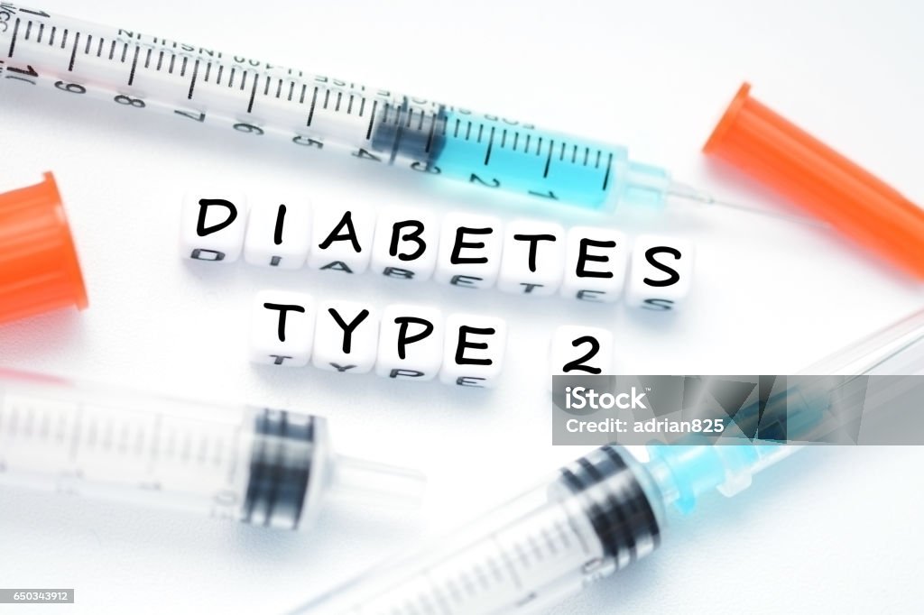 Type 2 diabetes text spelled with plastic letter beads placed next to an insulin syringe Type 2 Diabetes Stock Photo