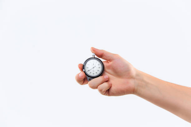 istock hand holding a stopwatch against  white backgroun 650383420