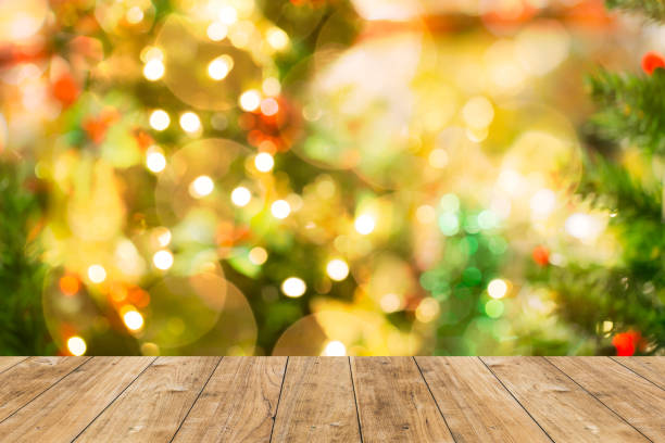 istock blur bokeh Christmas light background with wood floor 650387172