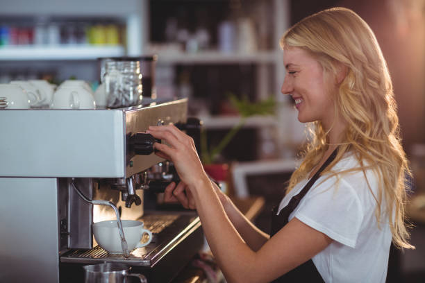 istock Smiling waitress making cup of coffee 650387526