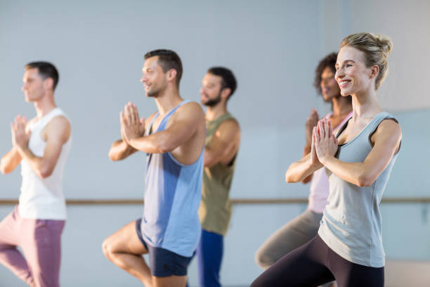 istock Group of people performing yoga 650389120