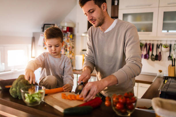 istock Father and son preparing healthy food in the kitchen 650407076