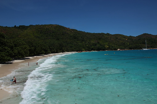 People enjoy snorkling and swimming at the beach Anse Lazio on Praslin Island, Seychelles.