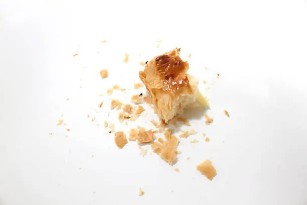Crumbs of bread on white background