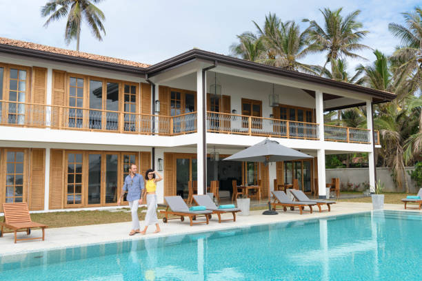 istock Mid adult couple taking a stroll by the pool on vacation 650466928