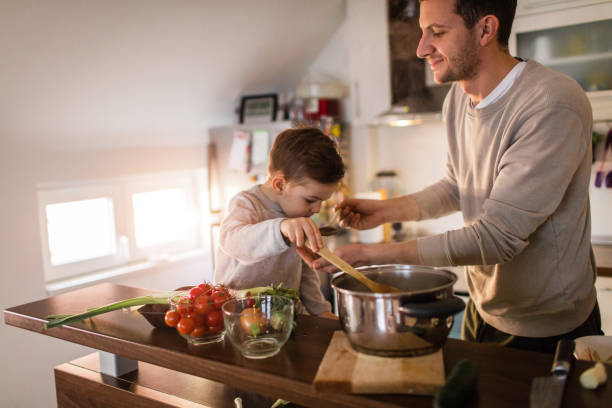 istock Father and son tasting a soup 650469010
