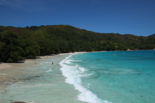 People enjoy snorkling and swimming at the beach Anse Lazio on Praslin Island, Seychelles.