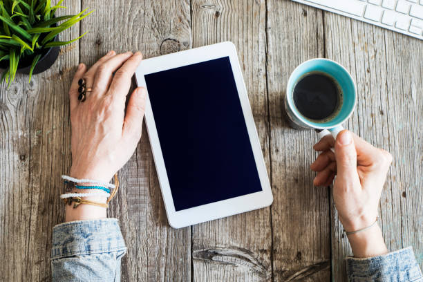 istock Woman hands using digital tablet on wooden table 650470234