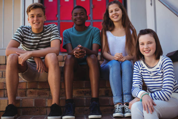 istock Portrait of students sitting on staircase 650470282