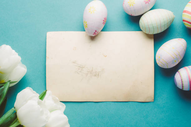 istock White tulips and Easter eggs on a green background. The concept of Easter or spring 650471166
