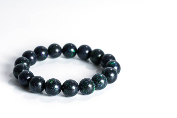 istock Beautiful rare Black Opal beads in bracelet on white background 650486606