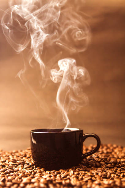 istock warm black cup of coffee on  roasted coffee beans 650489562