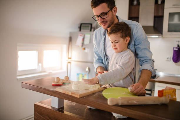istock Cute little baker and his father 650501070