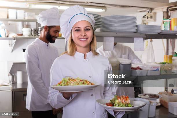 Chef And His Assistants Preparing Meal Stock Photo - Download Image Now - Cafe, Chef, Adult