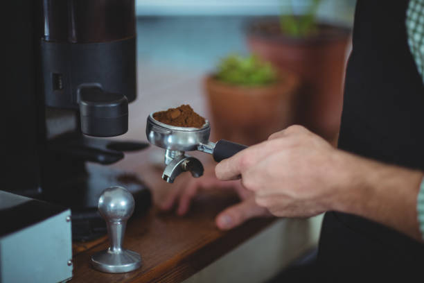 istock Waiter holding portafilter filled with ground coffee 650523736