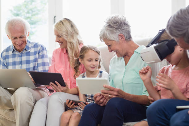 multi-generationen-familie mit digitalen tablet, handy und virtuelle kopfhörer im wohnzimmer - grandmother senior adult child multi generation family stock-fotos und bilder