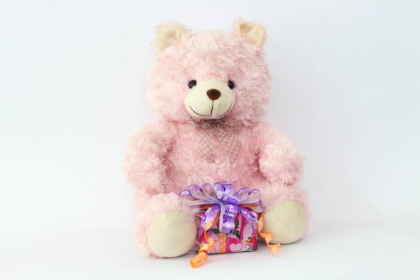 istock Pink teddy bear and gift boxes on a white background. 650559780