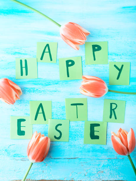 istock Happy Easter background tulips flowers hand written letters 650564632
