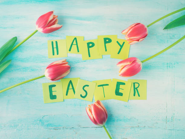 istock Happy Easter background tulips flowers hand written letters 650574780