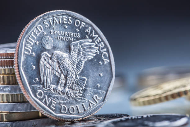 istock Dollar coins. USA Dollar coins standing on edge supported on coins 650589558