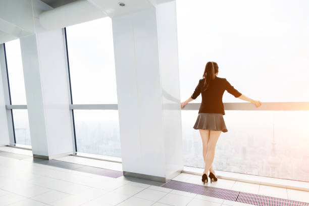 istock Businesswoman looking through the window 650594654