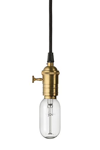 Close up of a vintage, retro style lightbulb hanging on the cord isolated on white background