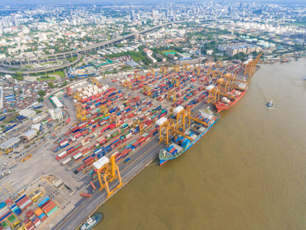 istock Aerial view Container Cargo freight ship with working crane bridge in shipyard 650607980