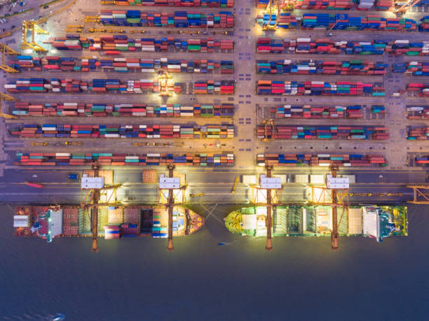 istock Aerial view Container Cargo freight ship with working crane bridge in shipyard 650608020