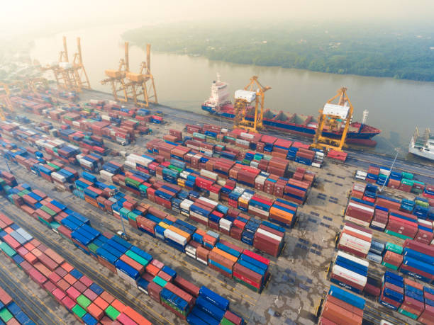 istock Aerial view Container Cargo freight ship with working crane bridge in shipyard 650608070