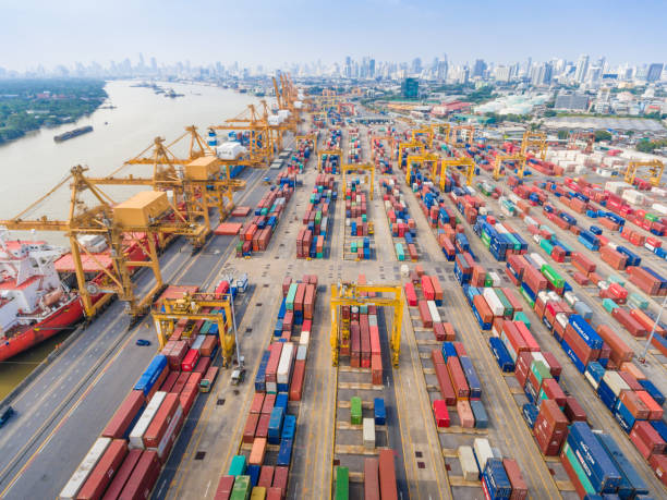 istock Aerial shot Container Cargo freight ship with working crane bridge in shipyard 650612634