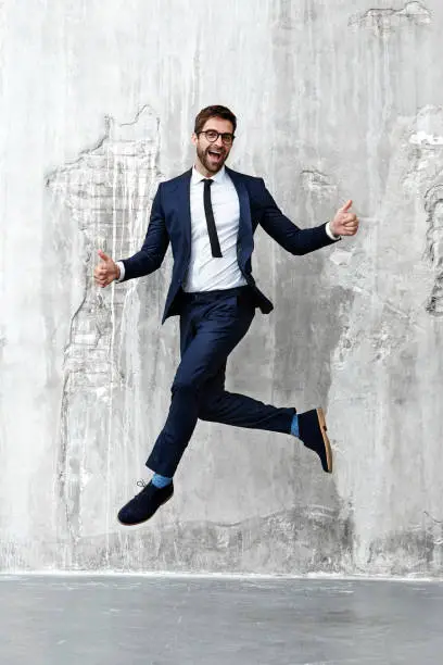 Businessman jumping in air, portrait