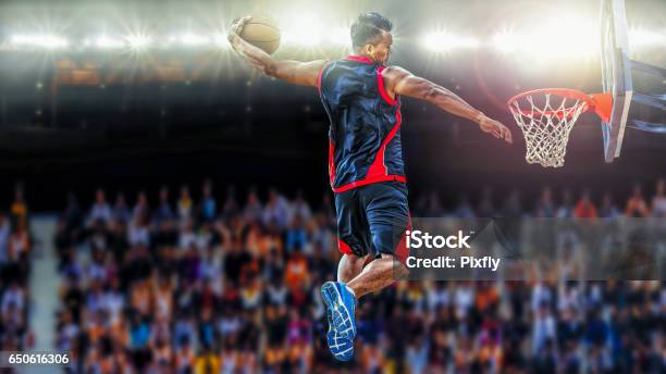 Asketball Player Scoring An Athletic Slam Dunk Shoot Stock Photo - Download Image Now