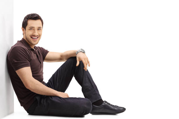 istock Young guy sitting on the floor and leaning against a wall 650617692