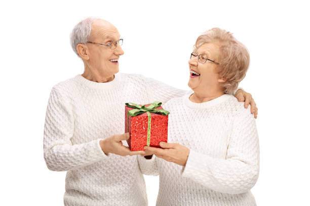 istock Cheerful elderly couple exchanging gifts 650620474