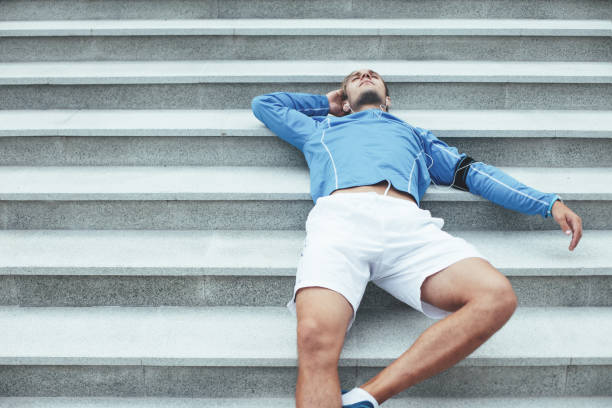 istock Tired athlete resting on the stairs 650624066