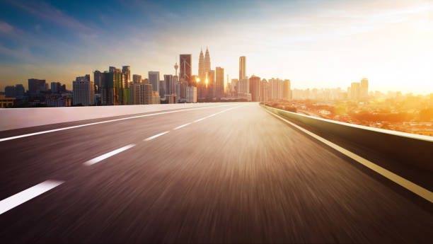 istock Highway overpass motion blur with city skyline background . Sunset scene . 650625478