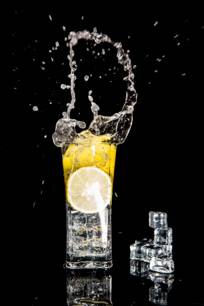 istock splash in a glass with lemon and ice on a black background 650629454