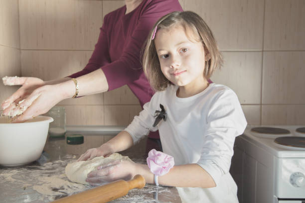 istock Little cute girl making cookies 650633978
