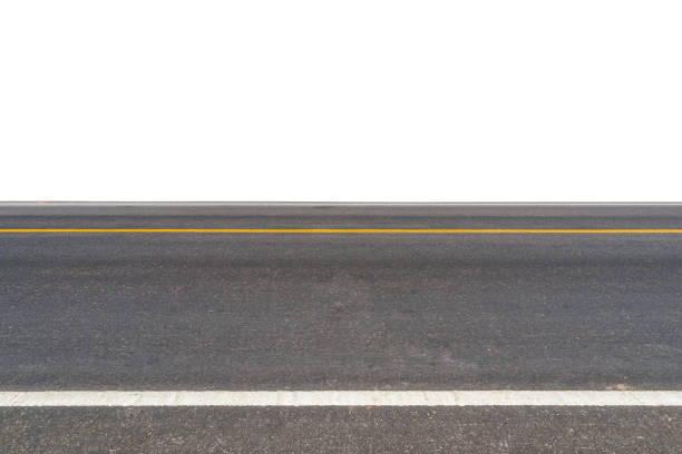 A well-maintained six-lane highway stretching straight ahead, surrounded by lush green trees and grass on both sides. Ideal for concepts related to travel, road infrastructure, construction, transportation, and environmental planning.