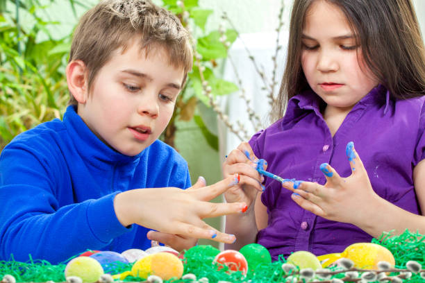 istock Mother and her children paint easter eggs 650647666