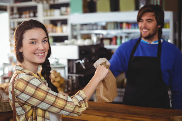 istock Woman receiving parcel from waiter at counter 650648108